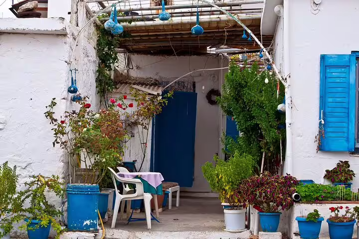 Cozy outdoor patio in Apokoronas with blue accents and colorful plants, perfect for exploring traditional Cretan life.