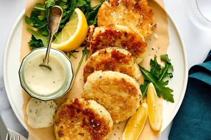 Crispy fish cakes with lemon and tartar sauce featured on the Ultimate Lisbon Food Tour's tavern delights.