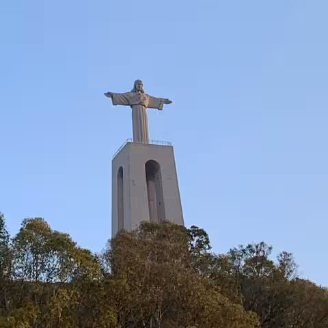 Cristo Rei statue towering above Lisbon on a private Tagus River sightseeing cruise with panoramic views