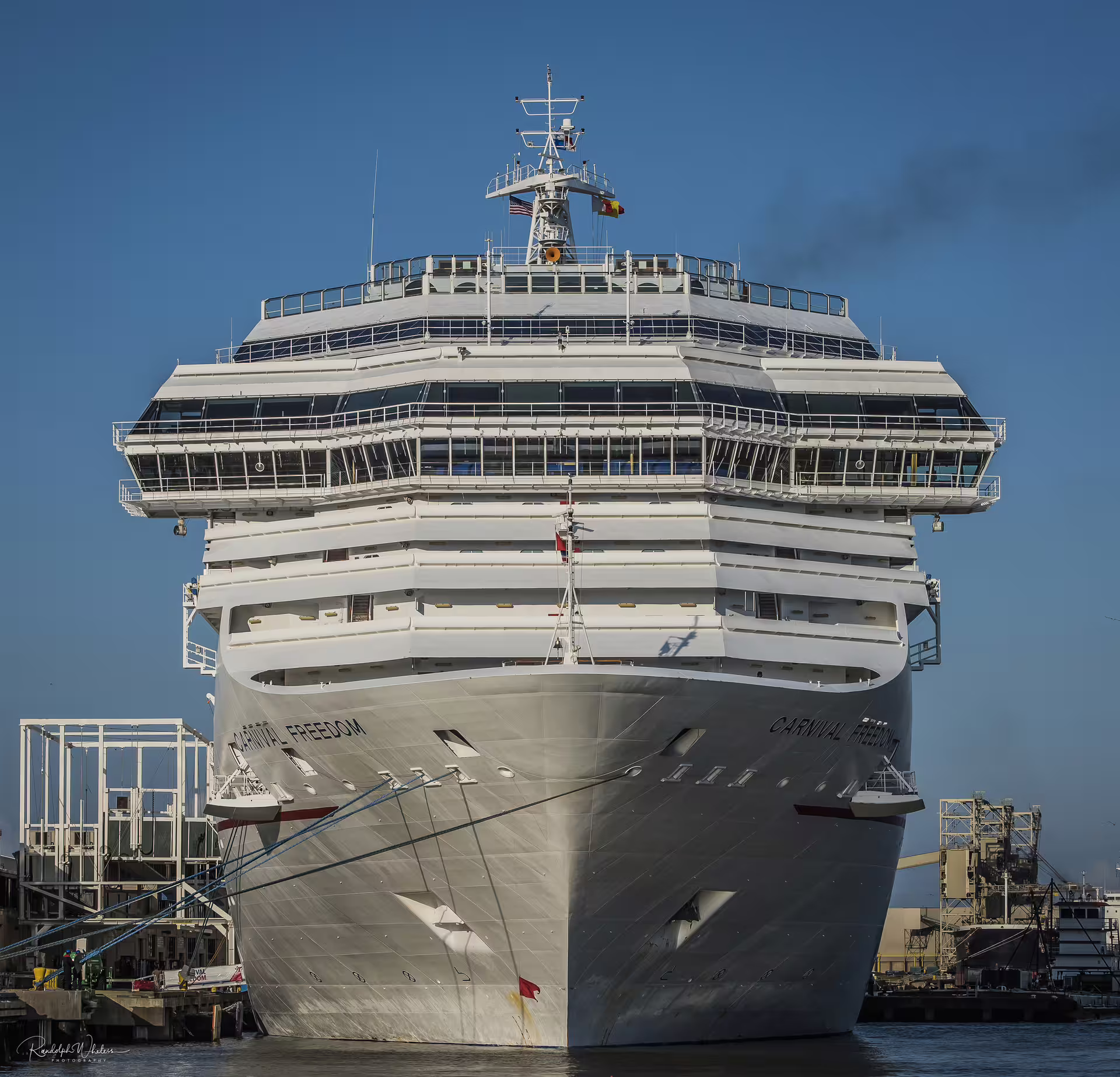 Front view of a large white cruise ship moored at Civitavecchia Port, departure point for private transfer to Fiumicino