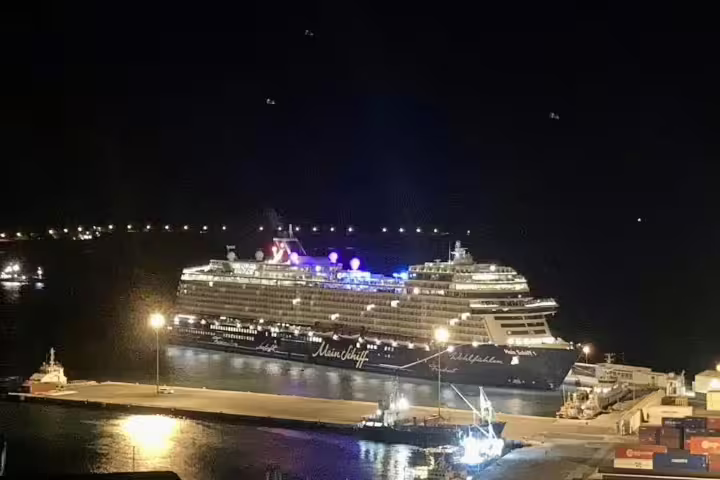 Illuminated cruise ship docked at Mindelo port, São Vicente, capturing the vibrant nightlife of this Cape Verdean island.