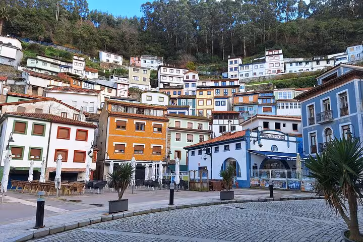 Colorful hillside houses in Cudillero, showcasing the charming architecture of this coastal village on the tour.
