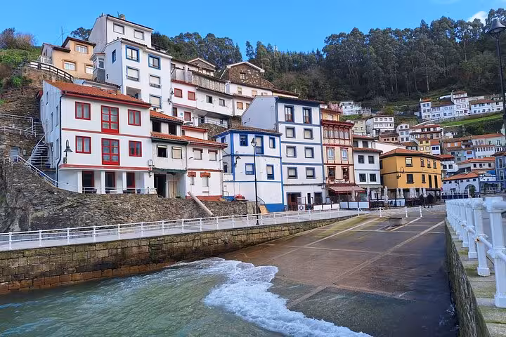 Colorful hillside houses in Cudillero village by the sea, a highlight of the Cudillero and Aviles tour from Oviedo.