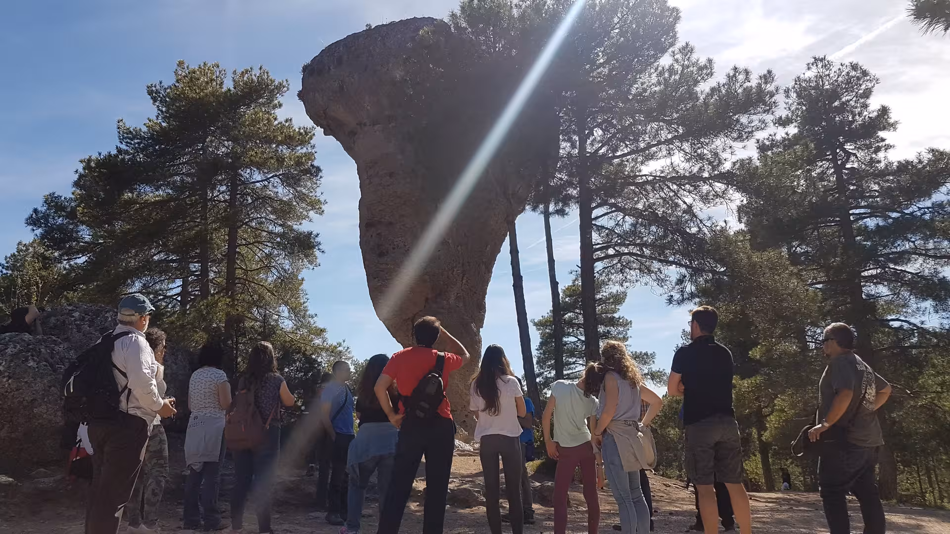 Tour group admiring the Tormo Alto rock formation in Ciudad Encantada, Cuenca day trip from Madrid