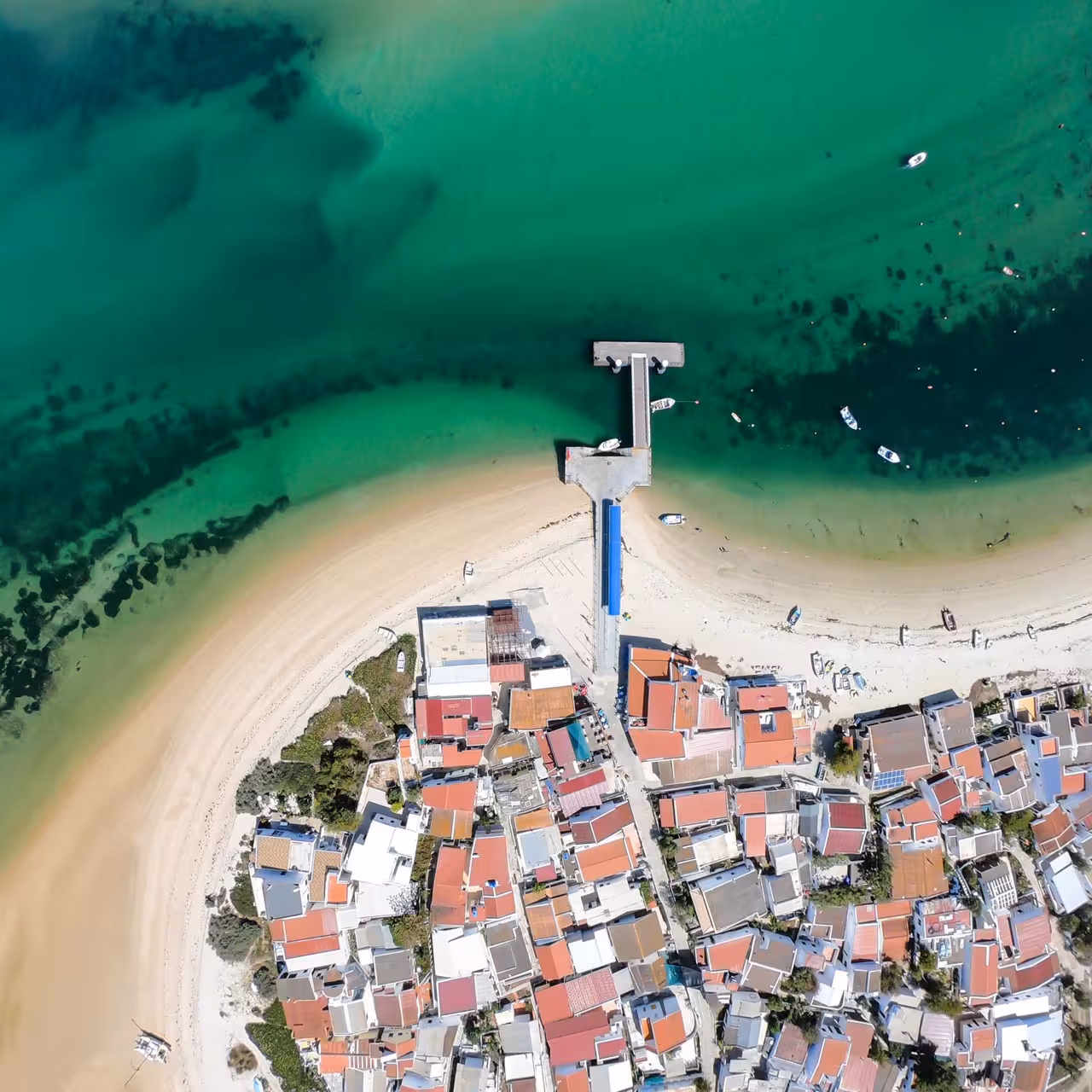 Aerial view of Culatra Island pier and sandy beach in Ria Formosa on a 3-island full-day boat tour from Faro