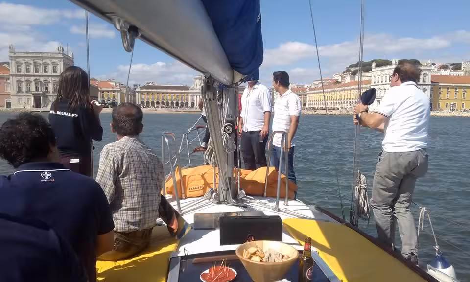 Guests enjoy a cultural sail tour Lisbon on the Tagus River with Praça do Comércio waterfront views