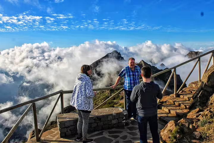 Tourists enjoy breathtaking mountain views above the clouds during a Curral das Freiras & Peaks 4WD adventure.