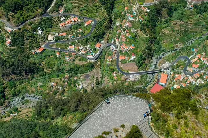 Aerial view of winding roads and terraced hillsides in Curral das Freiras, perfect for a scenic 4WD tour adventure.