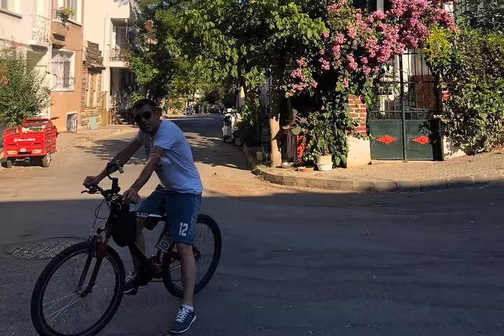 Cyclist on shaded Büyükada road, car-free Princes Islands day trip from Istanbul with Heybeliada ferry ride