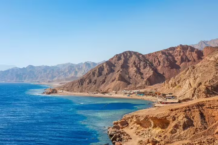 Red Sea coastline near Dahab with rugged mountains, scenic stop on Sharm to 3 Pools National Park tour