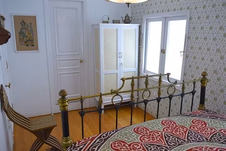 Cozy dahabiya cruise cabin with brass bed, wardrobe and window on 5-day Nile cruise Luxor to Aswan