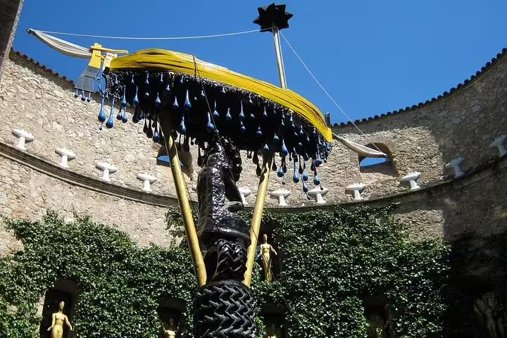 Iconic courtyard sculpture at Dalí Museum in Figueres, featured on the Girona tour, displaying surreal artistry.