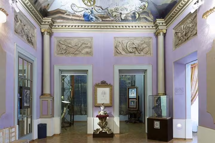 Elegant room with ornate ceiling and art displays at Dalí Museum, highlighting the cultural allure of the private tour.