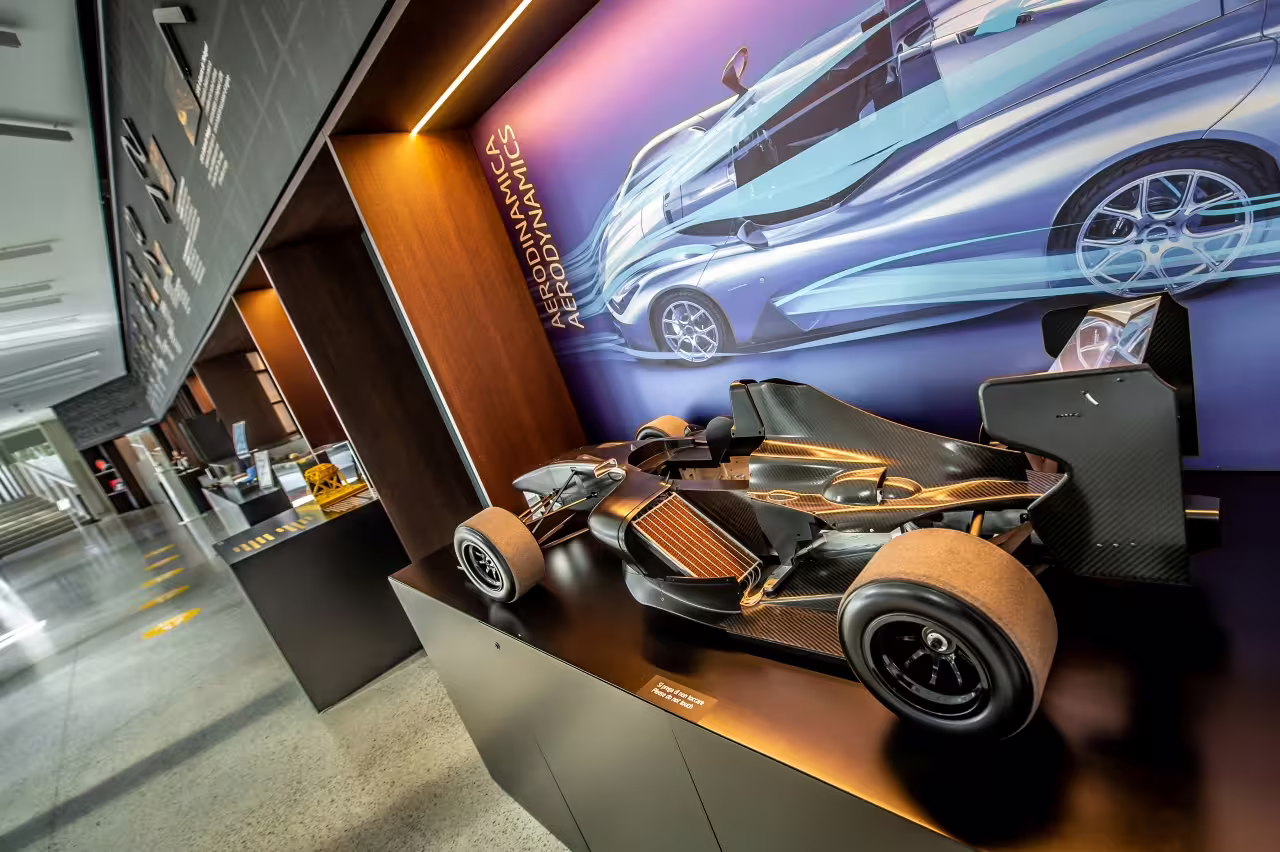 Aerodynamic race car model display at Dallara Academy, highlighting cutting-edge motorsport technology in Parma.