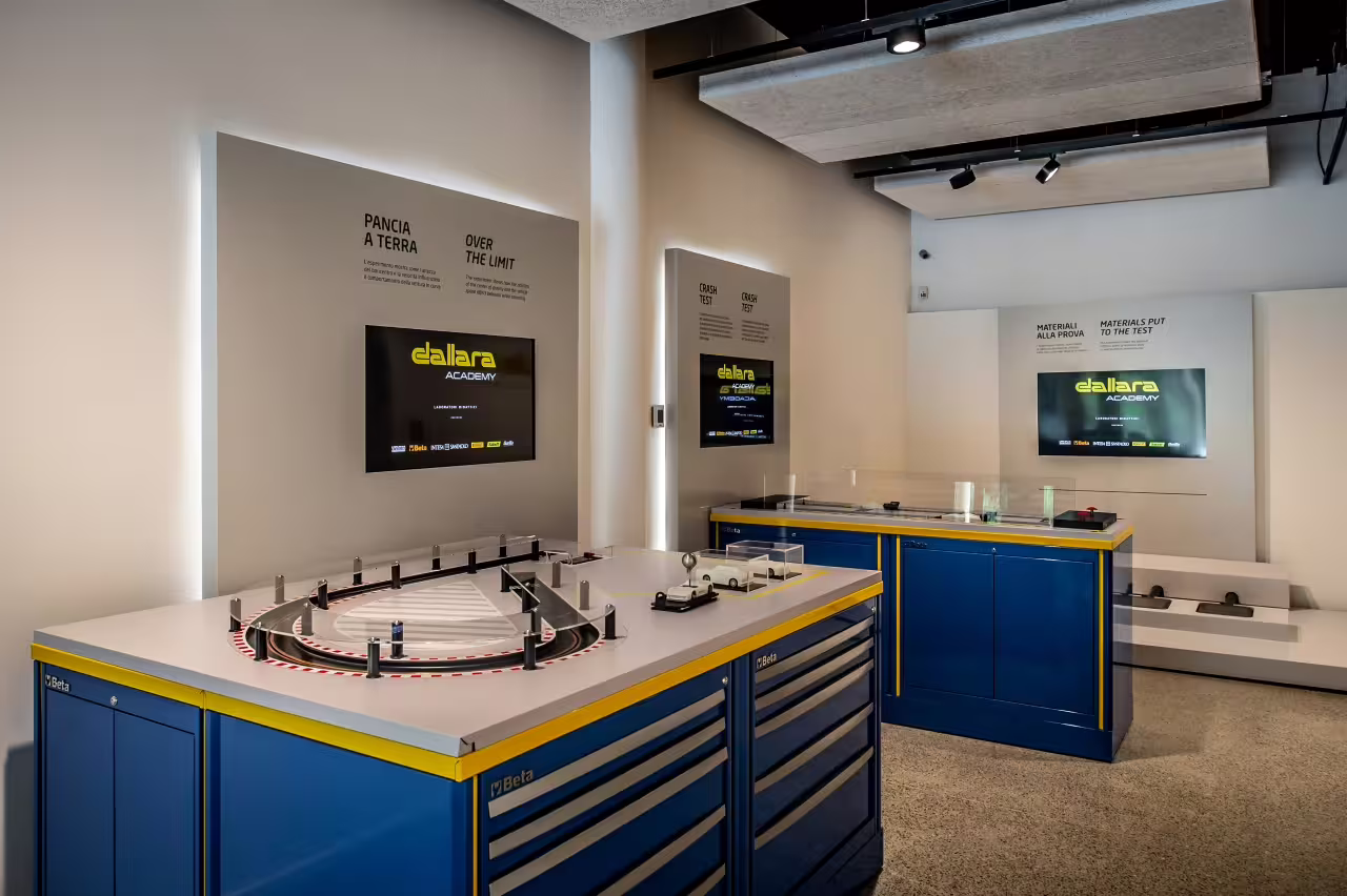Interactive learning exhibits at Dallara Academy showcasing motorsport technology and engineering in Parma.