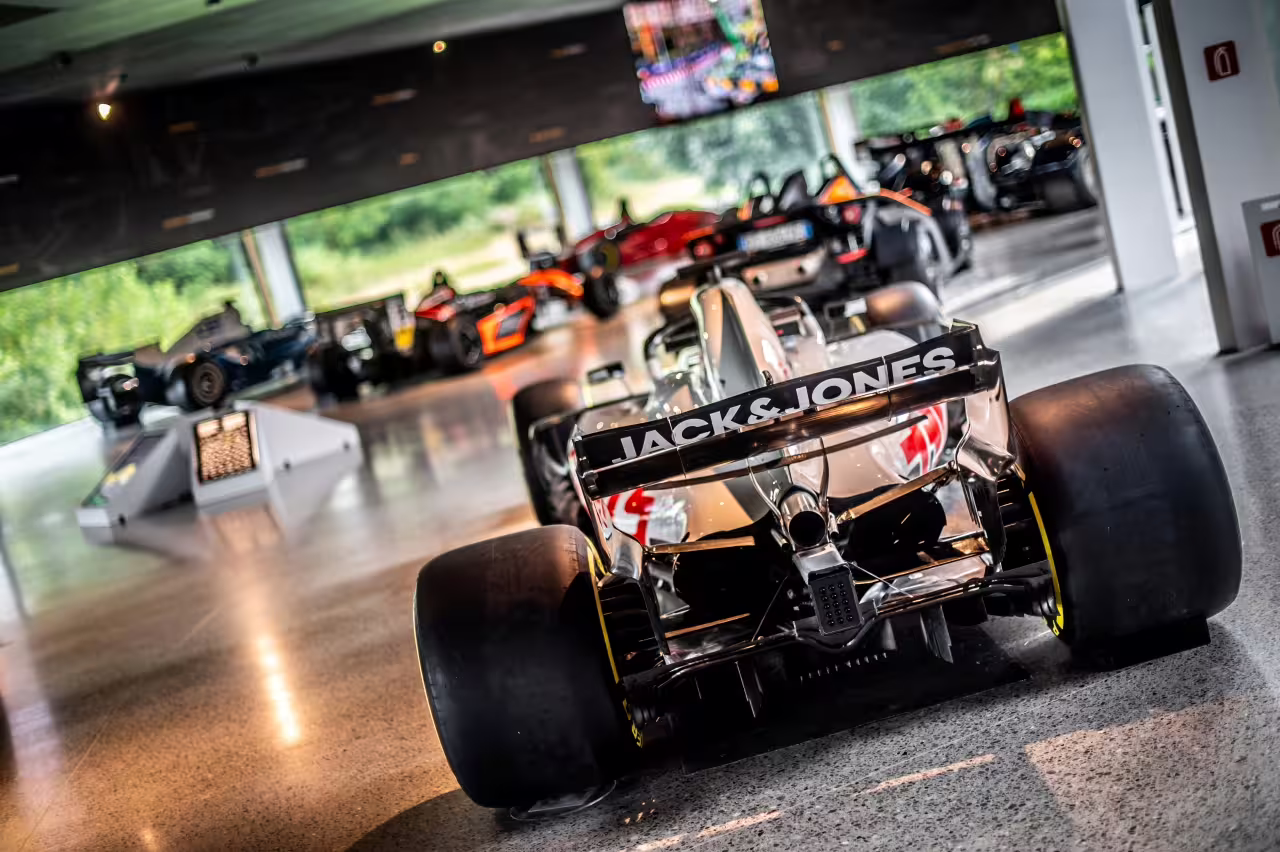 Experience the thrill of motorsport with a rear view of a high-performance race car at Dallara Academy in Parma.