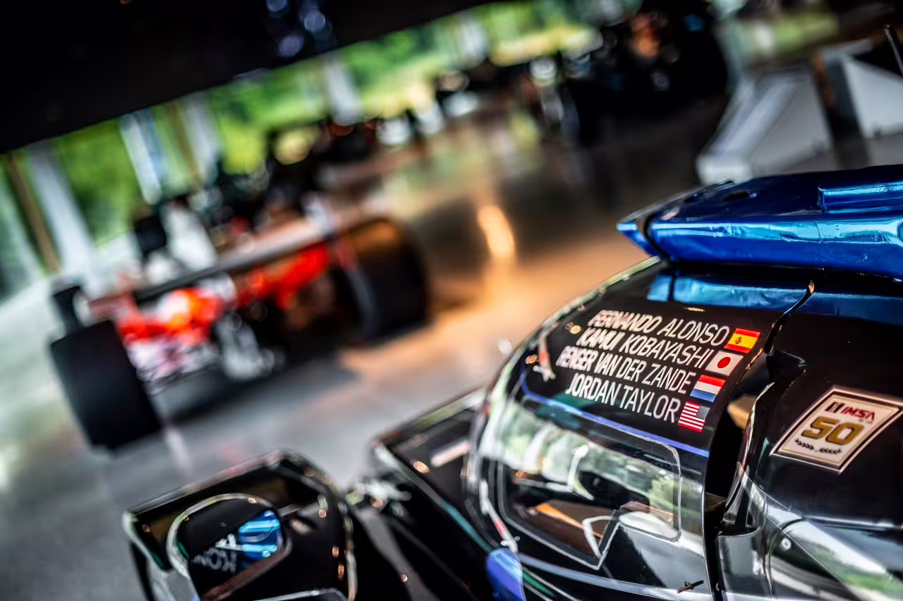 Close-up of a sleek race car at Dallara Academy, featuring international driver names, highlighting motorsport excellence.