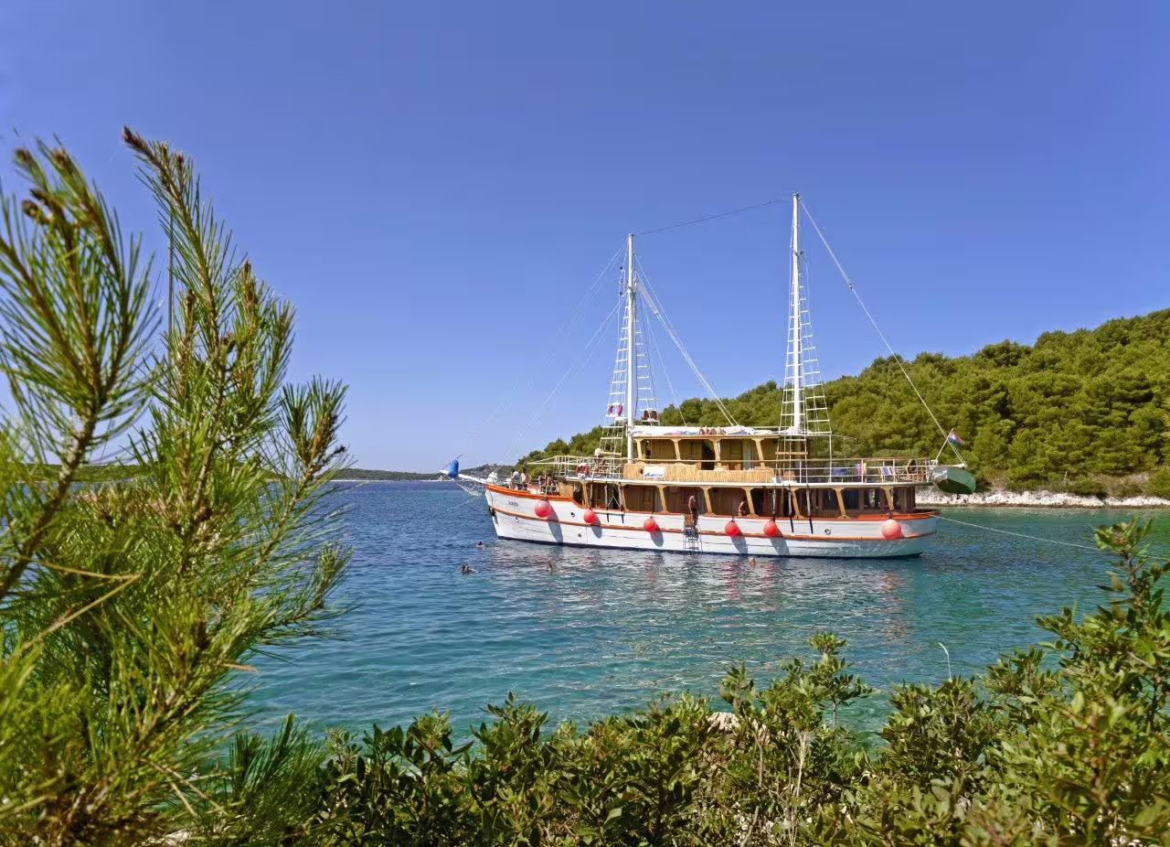 Standard category cruise boat anchored in a turquoise Dalmatian bay near Zadar and Split islands, Croatia