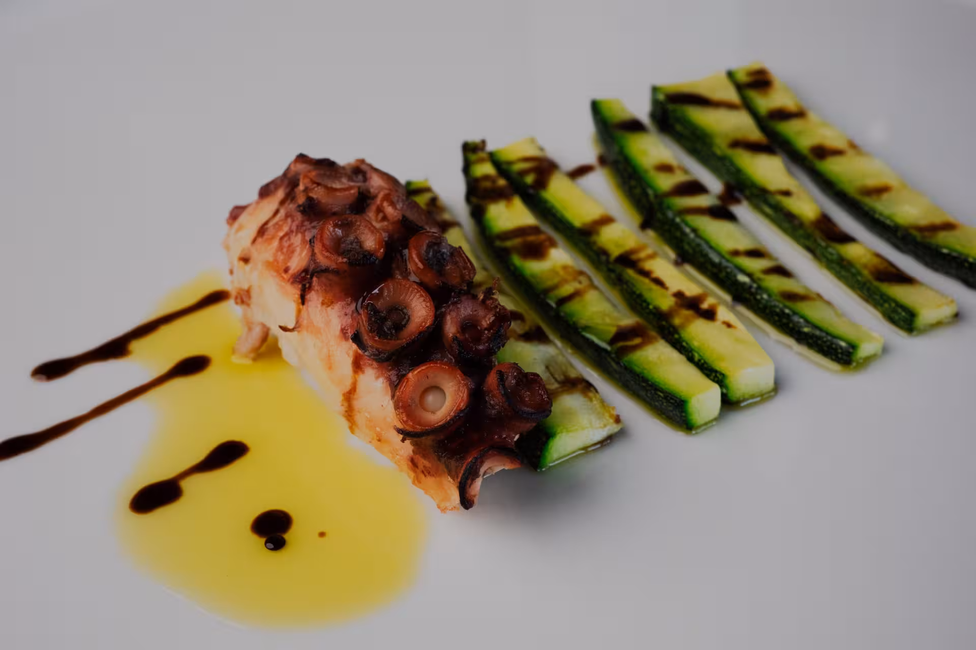 Dalmatian seafood dish in Split, octopus with grilled zucchini and olive oil, paired with local wine