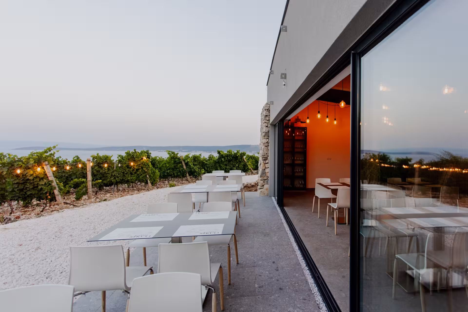 Modern Dalmatian winery terrace near Split overlooking vineyards and Adriatic, ideal for wine tasting