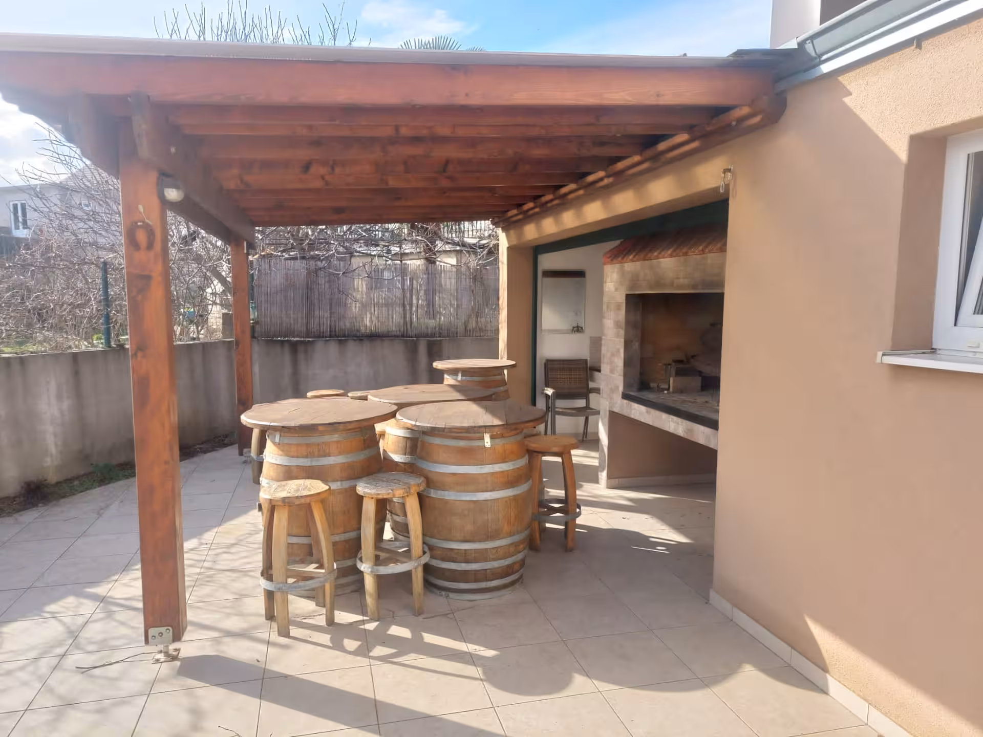 Rustic Dalmatian winery terrace with barrel tables and grill, part of Split to Imotski wine and dine tour