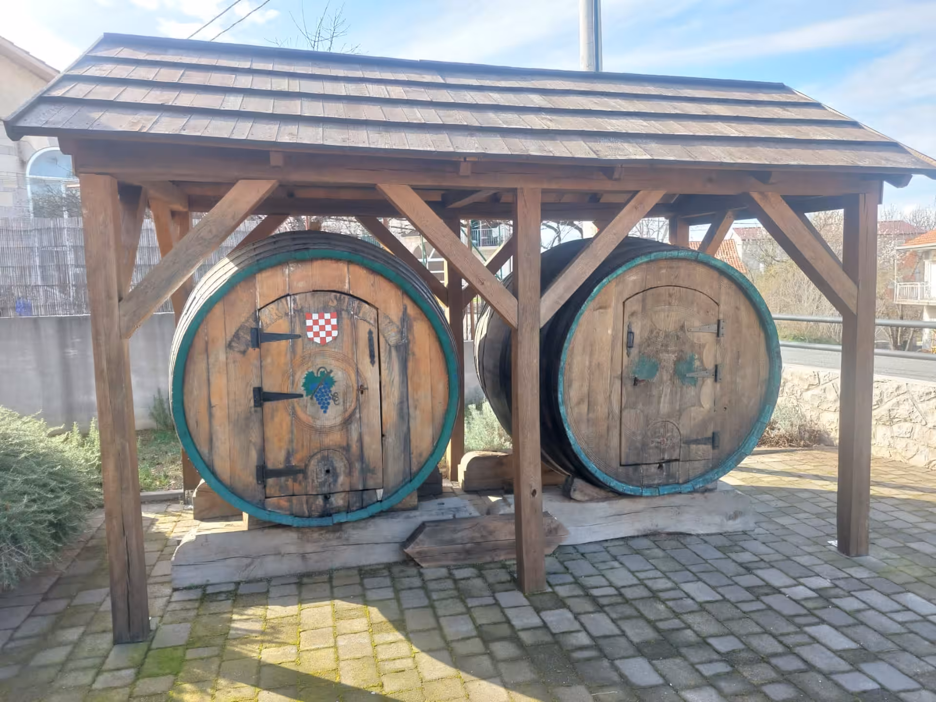 Traditional wooden wine barrels at a Dalmatian winery stop on the Split to Imotski Lakes wine and dine tour