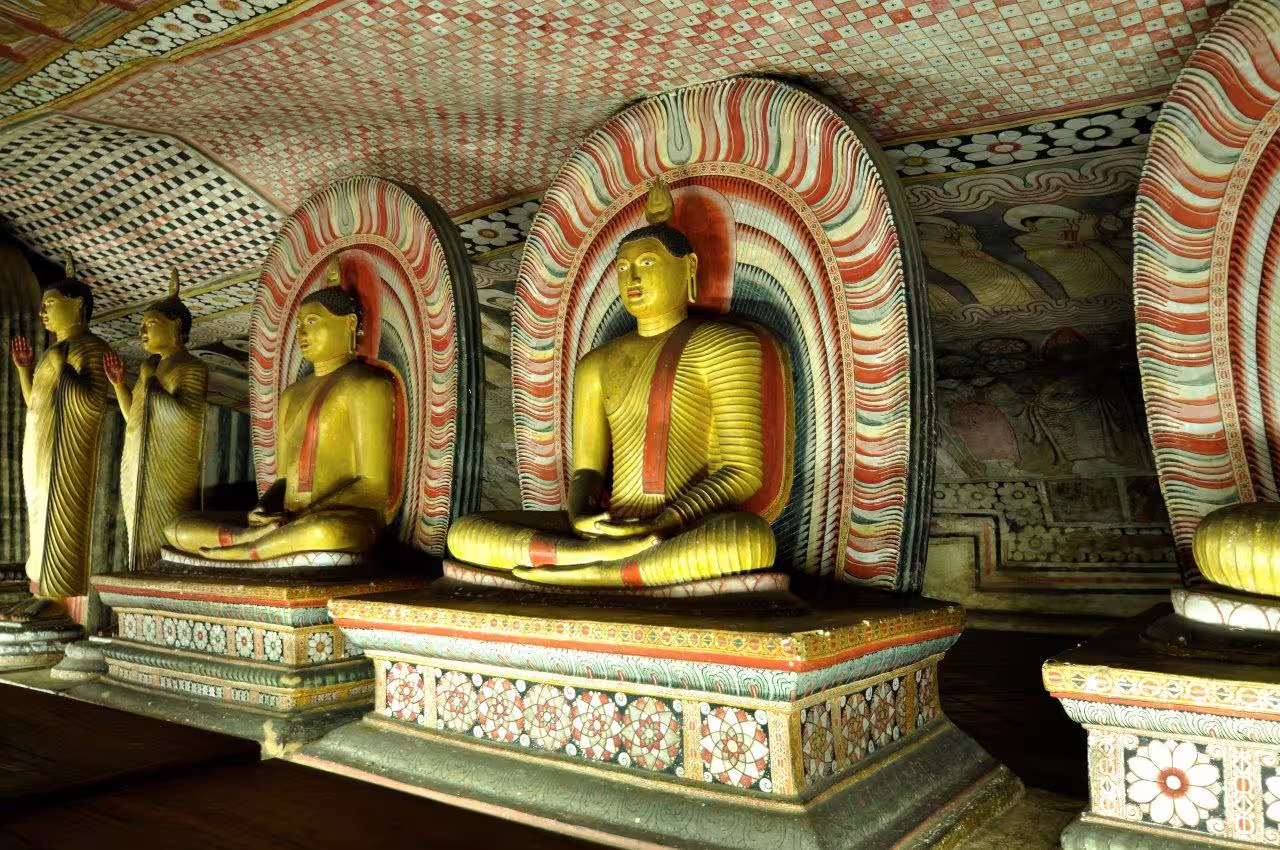 Admire the intricate Buddha statues and colorful frescoes of the historic Dambulla Cave Temple in Sri Lanka.