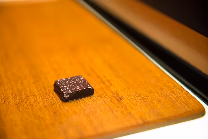 Piece of dark chocolate with sea salt on display at a patisserie in the Saint-Germain walking tour.