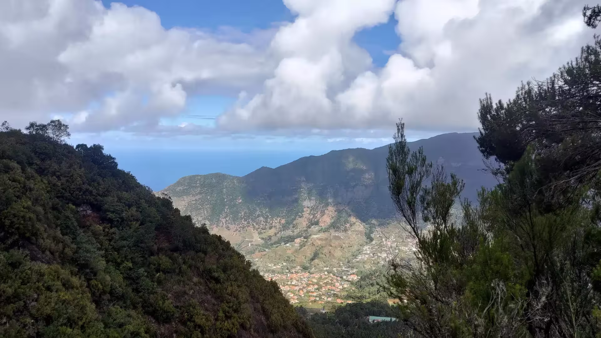 Stunning mountain view with lush greenery and ocean horizon, perfect for adventurous Dark Hike tours.