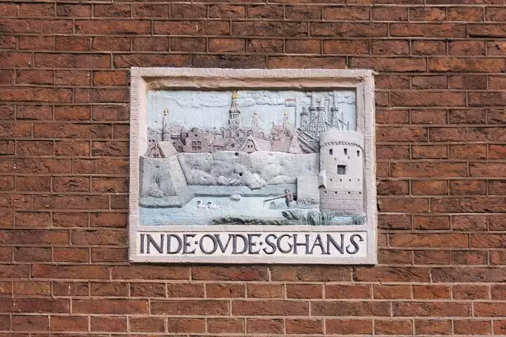 Historic wall relief of De Oude Schans in Amsterdam, a highlight on a private walking tour with a local guide