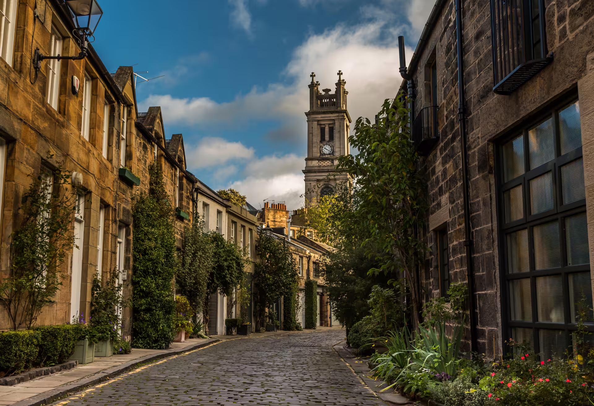 Dean Village cobbled street and clock tower on an Edinburgh 1-day self-guided walking tour audioguide