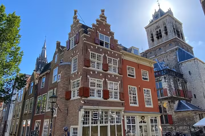 Delft historic center with Dutch gabled houses and church tower on Famous Holland day tour from Amsterdam
