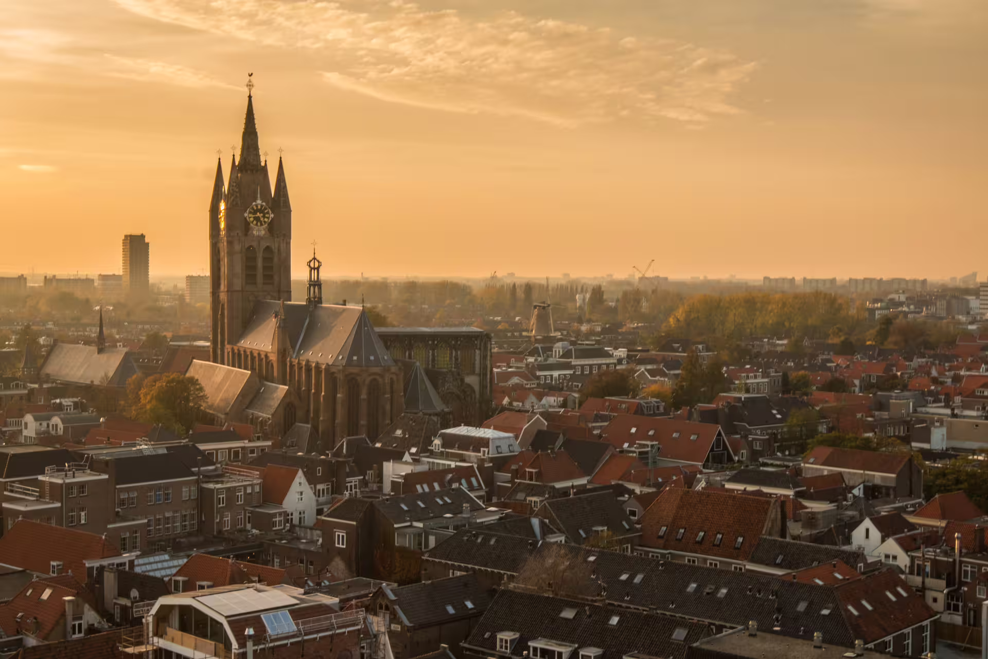 Sunset skyline of Delft with Nieuwe Kerk church tower, key sight on Delft in 1 day walking tour audioguide