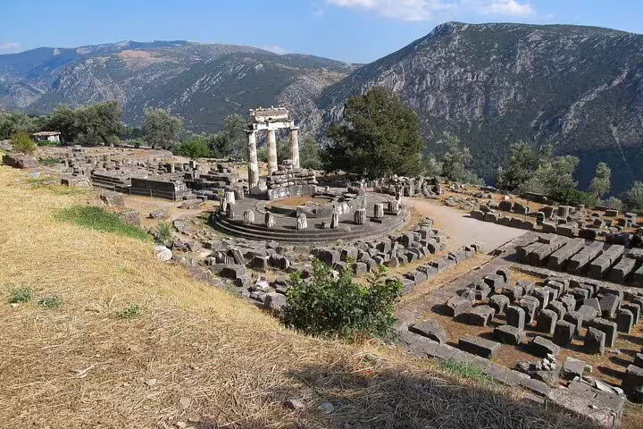 Ancient ruins of Delphi with mountainous backdrop, showcasing Greek history on a private 6-day tour.