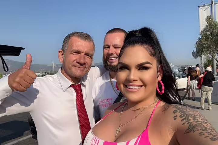 Happy travelers with private driver before Delphi and Meteora day tour from Athens, including dinner