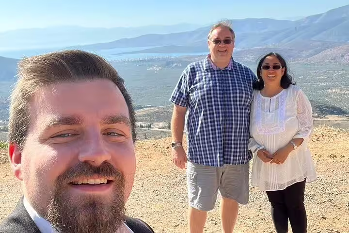 Tour guide selfie with travelers at Delphi viewpoint on private Athens to Delphi and Meteora day trip