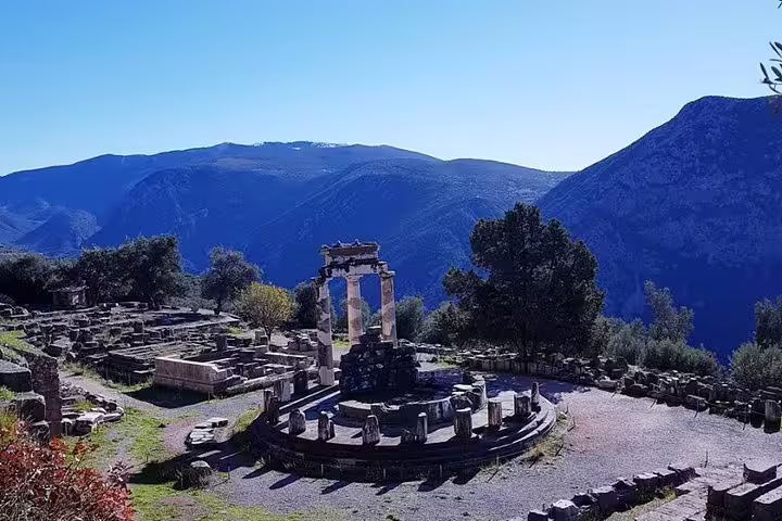 Delphi sanctuary viewpoint with Tholos and mountain panorama, photo from private Delphi to Athens transfer tour