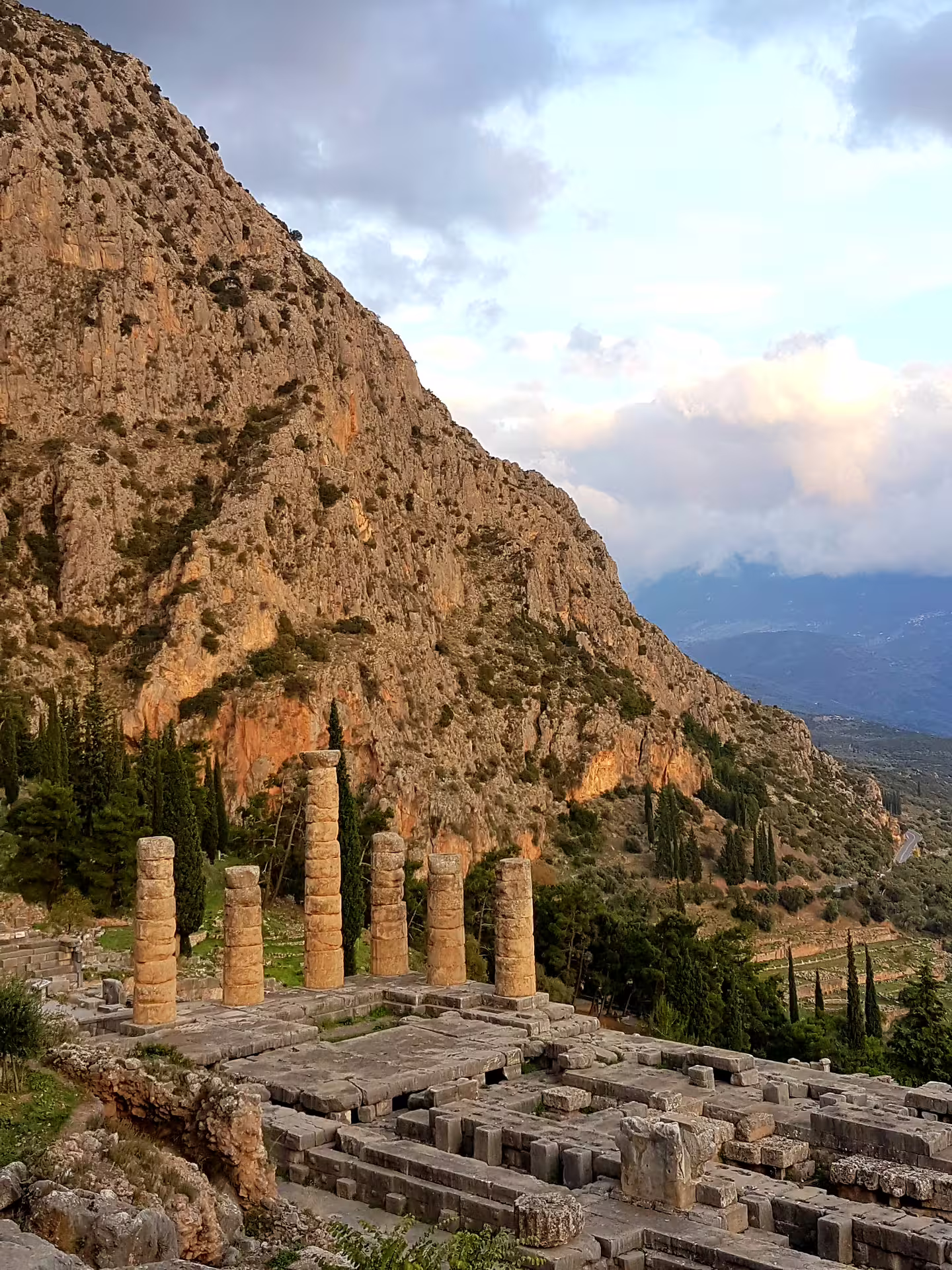 Ancient Delphi Temple of Apollo columns with Mount Parnassus views on a private Delphi tour from Athens