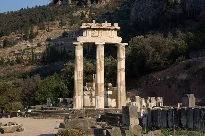 Explore the ancient ruins of the Tholos of Delphi on a private day trip from Athens, surrounded by stunning Greek landscapes.