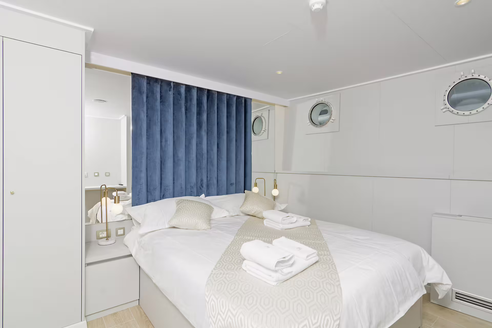 Modern deluxe boat cabin with double bed and portholes, Split and Dubrovnik region cruise accommodation