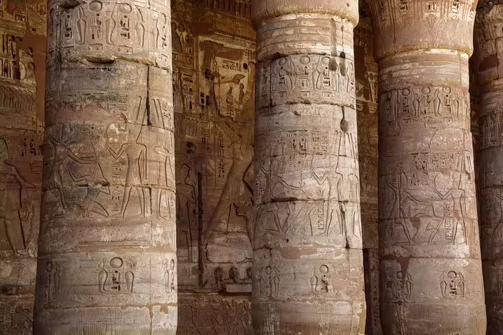 Carved columns with ancient hieroglyphs inside Dendera Temple, highlight of Dendera and Abydos day tour Egypt