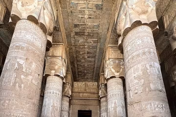 Close-up of the ornate, carved columns in Dendera Temple's Hypostyle Hall, highlighting ancient Egyptian architecture.