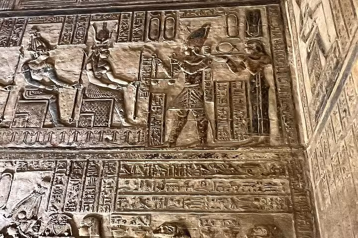 Intricate hieroglyphics and carvings on the walls of Dendera Temple, showcasing ancient Egyptian art and history.