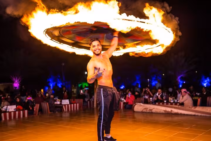 Desert camp fire show in Dubai, evening entertainment on multi day Dubai to Abu Dhabi adventure tour