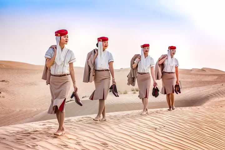 Desert fashion shoot in Dubai dunes with private travel photographer tour capturing editorial-style portraits at sunrise