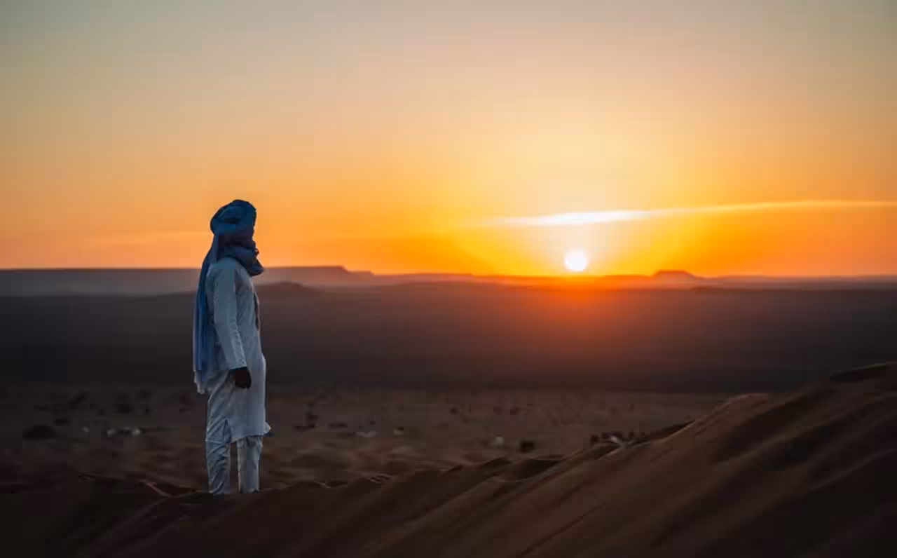 Witness a breathtaking desert sunset in Merzouga on a 4-day tour from Marrakech to Fez via Erg-Chebbi.
