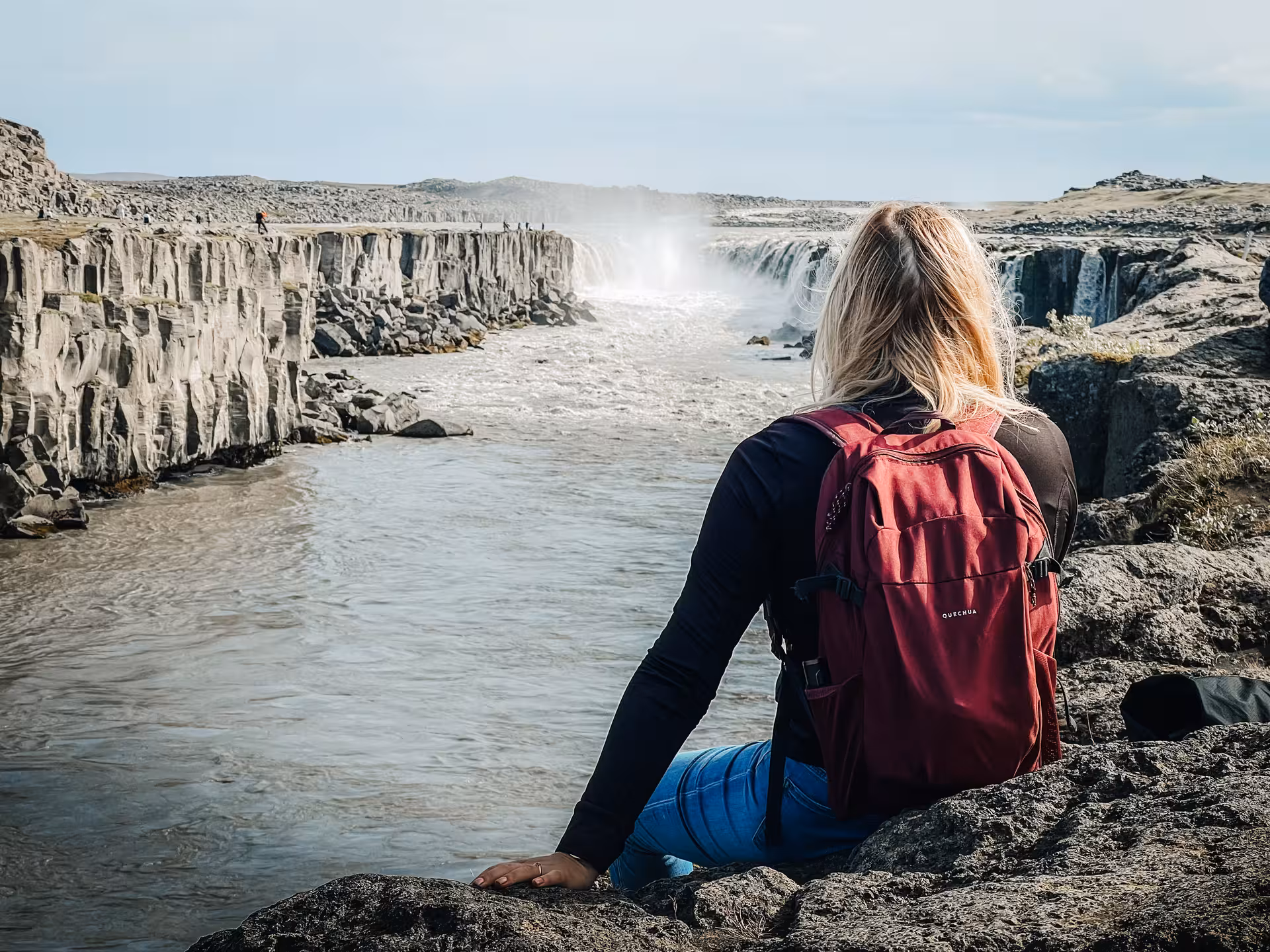 Traveler overlooks Dettifoss waterfall canyon on a private Diamond Circle tour in North Iceland