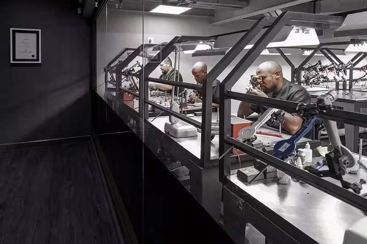 Diamond cutters in action at a workshop, showcasing craftsmanship during the Diamond Museum shared experience.