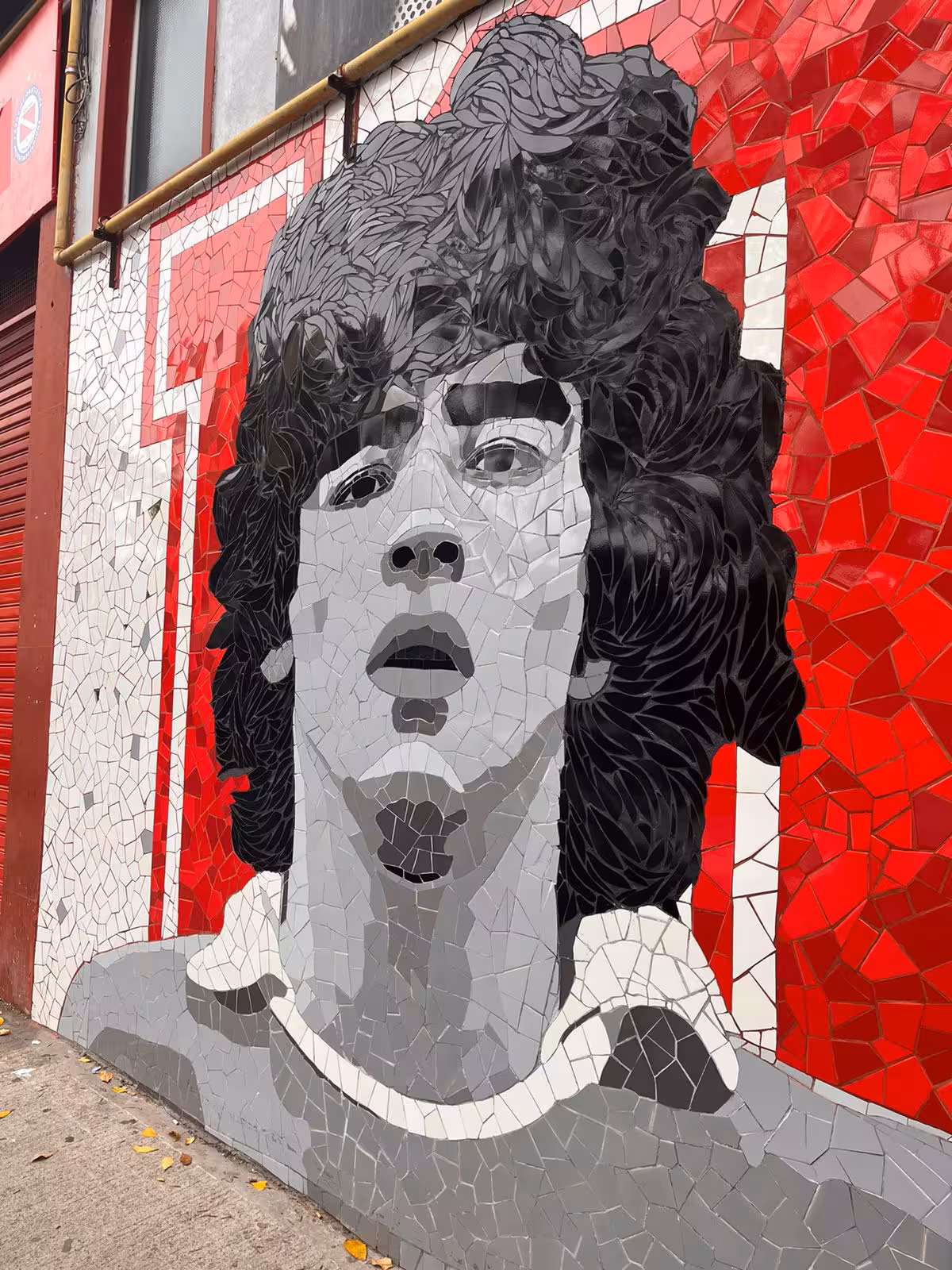 Mosaic street mural of Diego Maradona in Buenos Aires, iconic photo stop on the Maradona tour in La Paternal