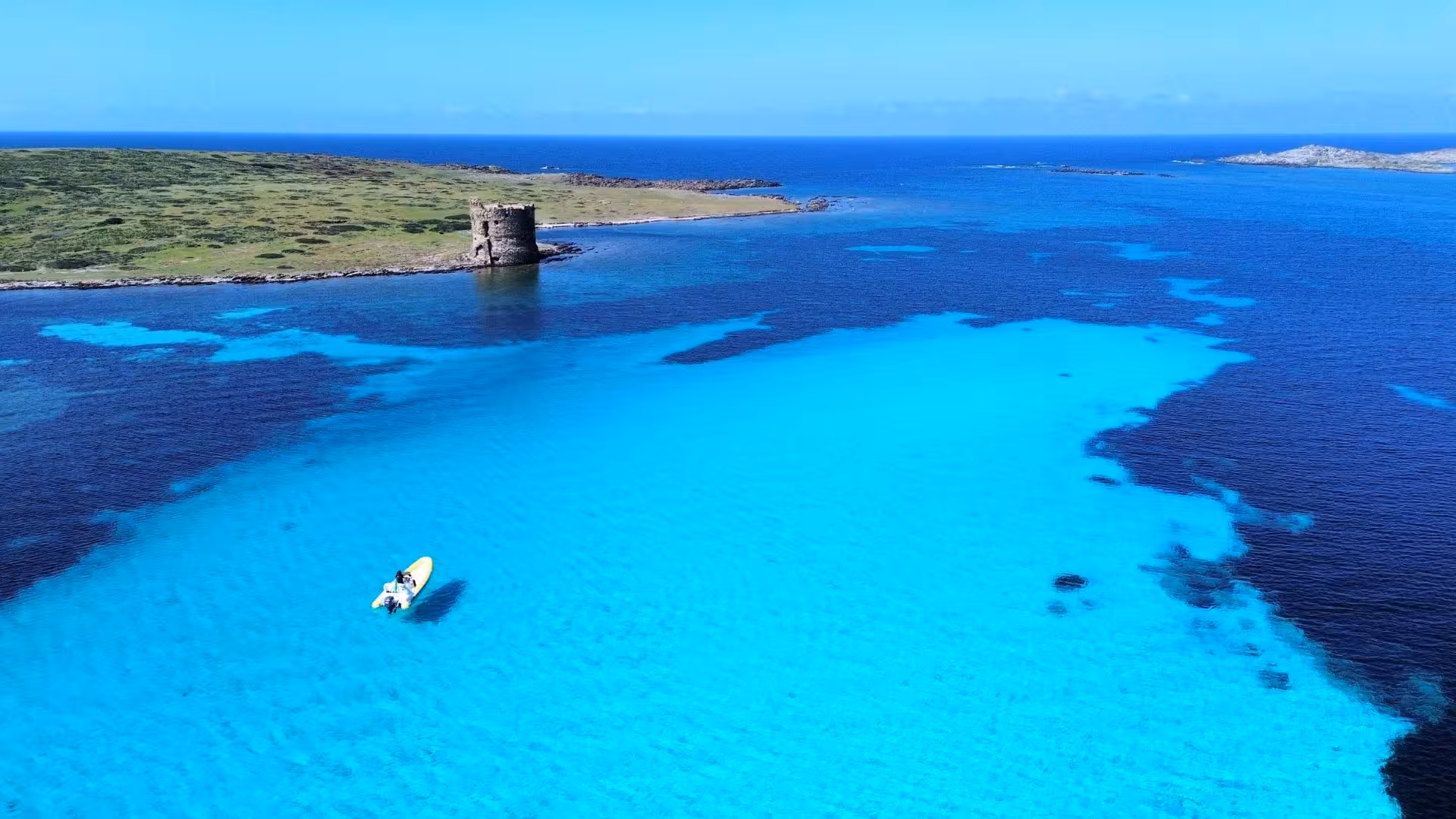 Dinghy sailing in the clear blue waters near Asinara Island, showcasing a scenic view ideal for Stintino tours.